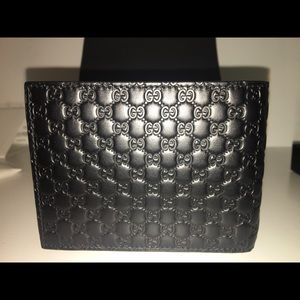 Gucci men’s black leather wallet, embossed, new